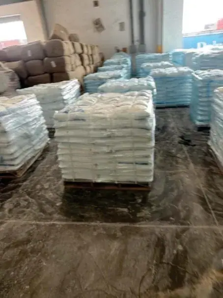 Pallets of bagged cargo stacked in a warehouse