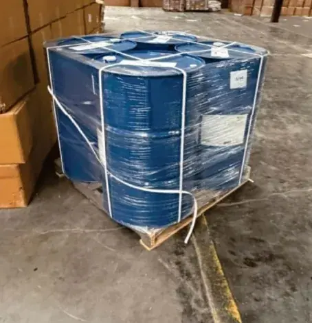 Blue drums shrink-wrapped and strapped together on a pallet