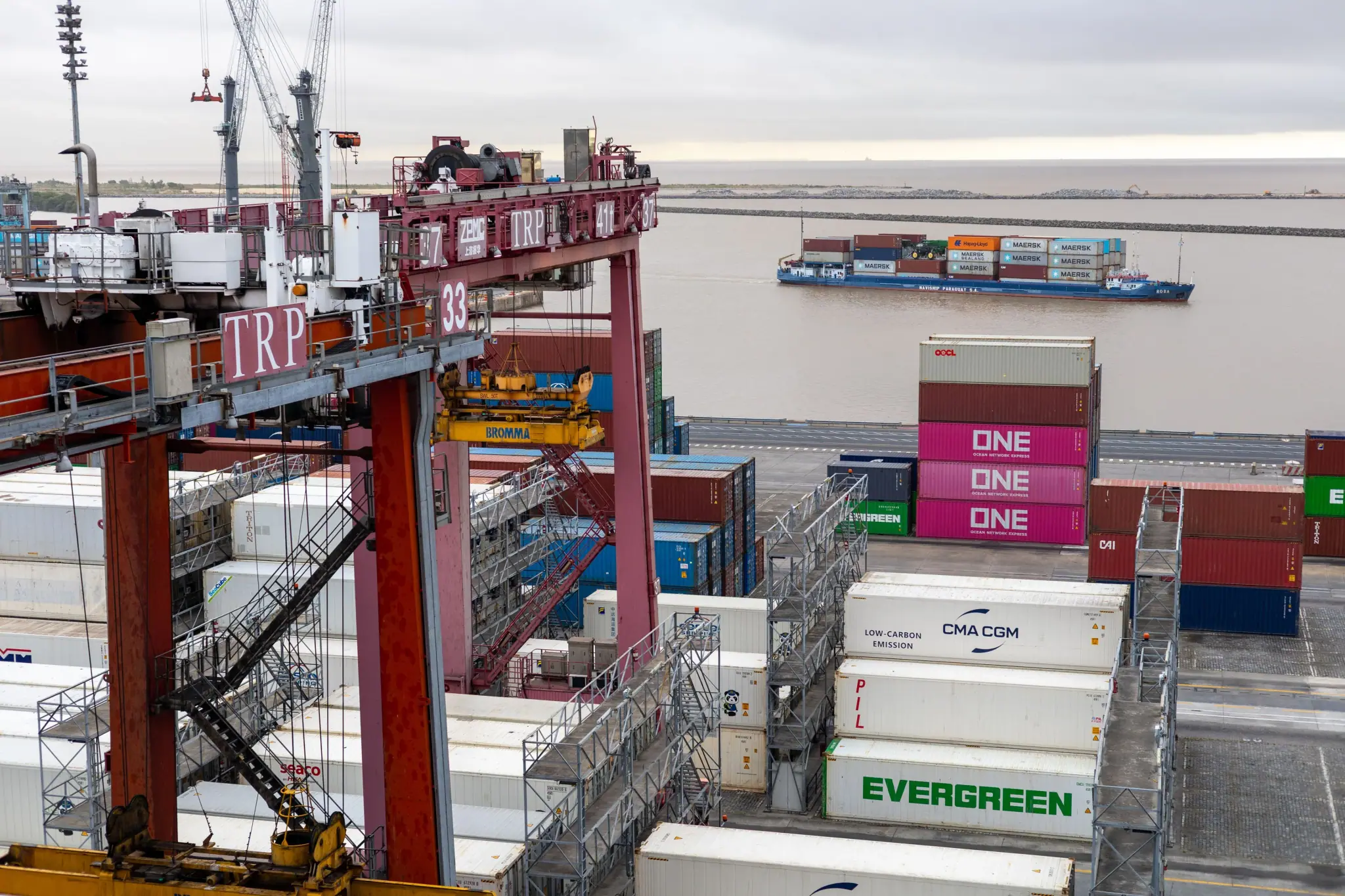 Container terminal gantry crane and stacked containers beside the quay