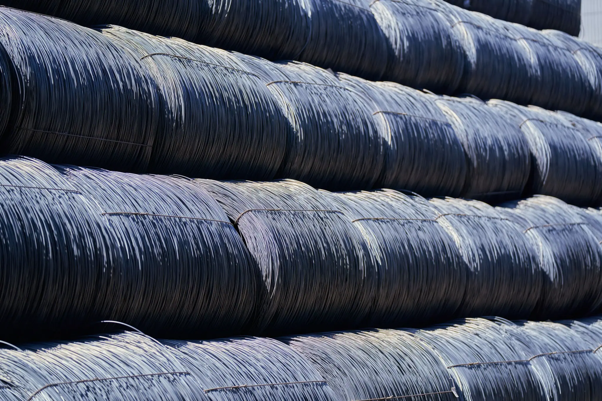 Close-up of tightly stacked steel wire coils